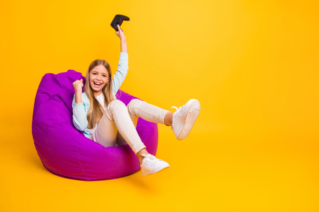 Little Girl Playing Video Games On Bean Bag 1024x682 1